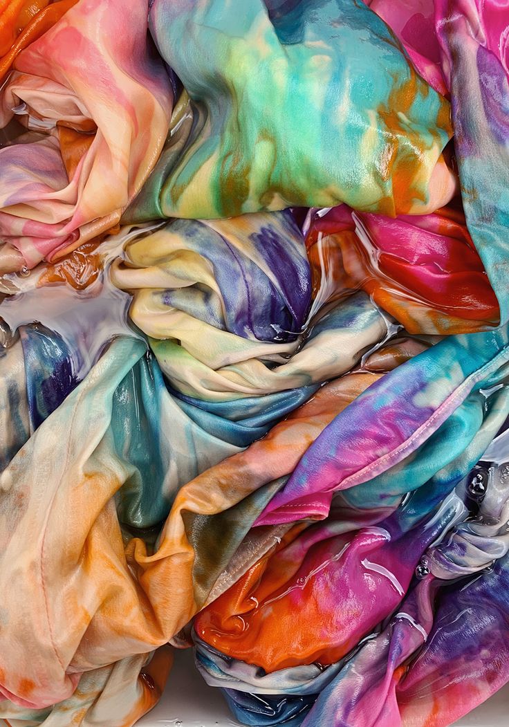 a pile of multicolored scarves sitting on top of each other