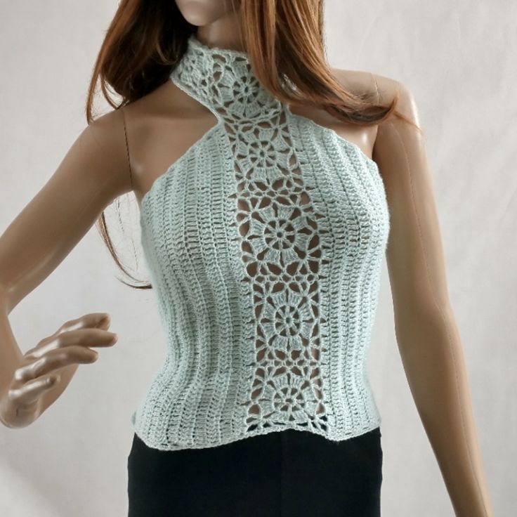 a mannequin wearing a white top with crochet