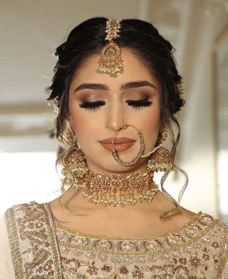 a woman with makeup and jewelry on her face