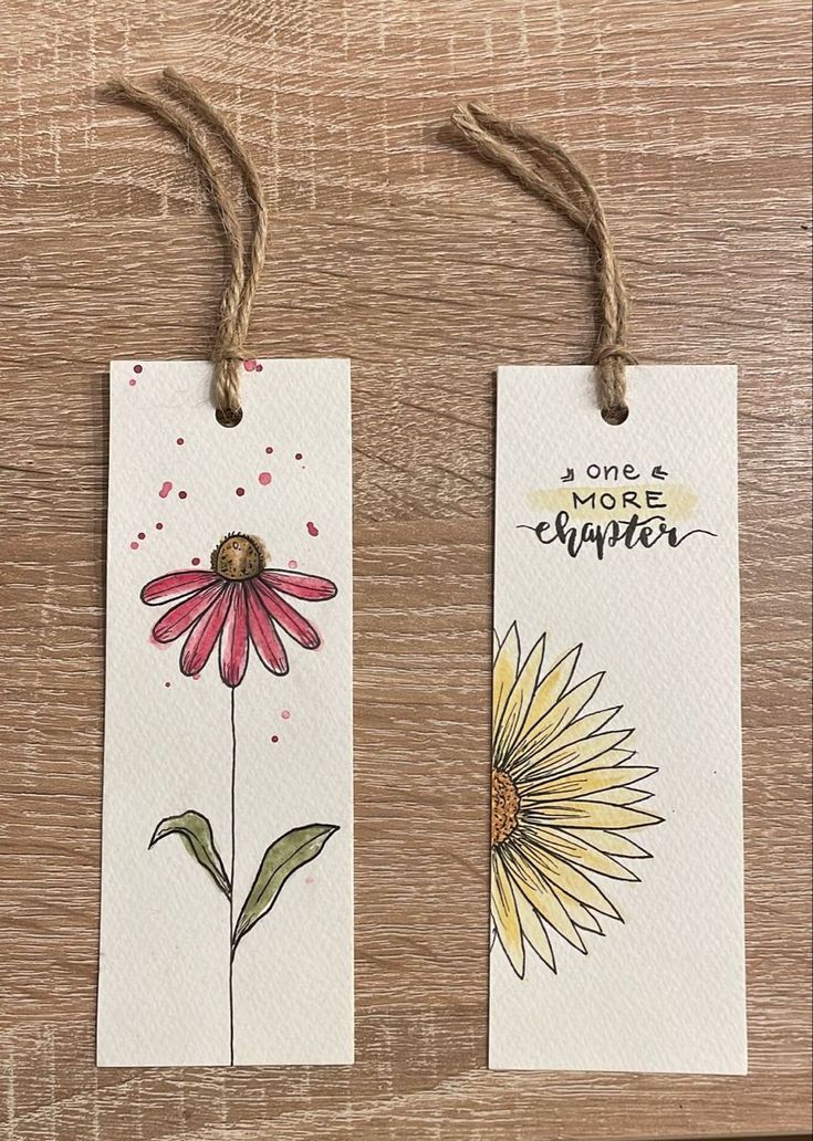 two tags with flowers painted on them