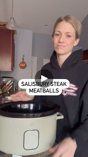 a woman standing in front of a slow cooker with the words salisbury steak meatballs