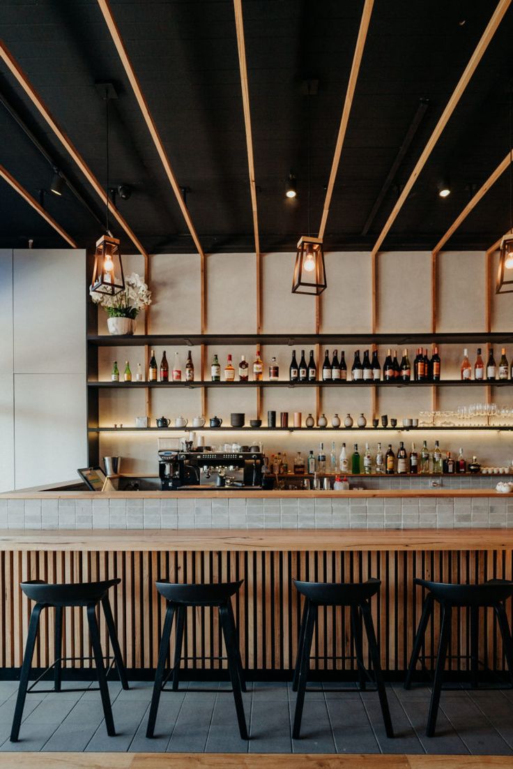 an empty bar with stools in front of it