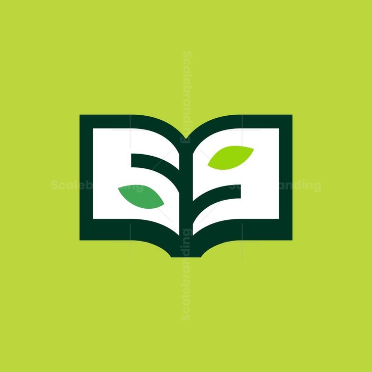 an open book with green leaves on it