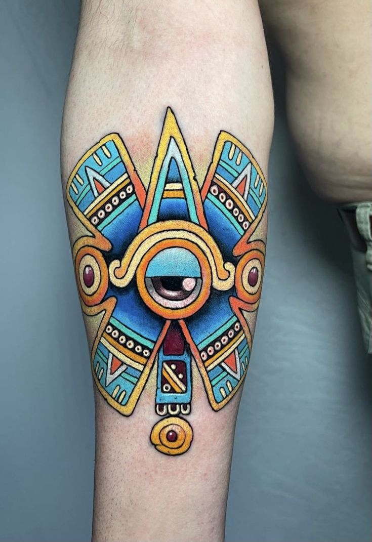 a colorful tattoo on the leg of a man