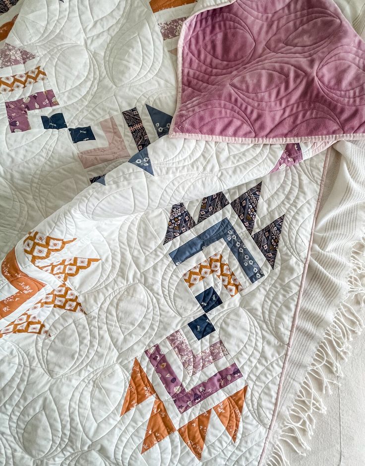 two quilts are laying on top of each other