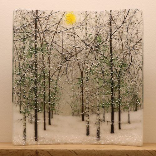 a painting of trees in the snow on a shelf