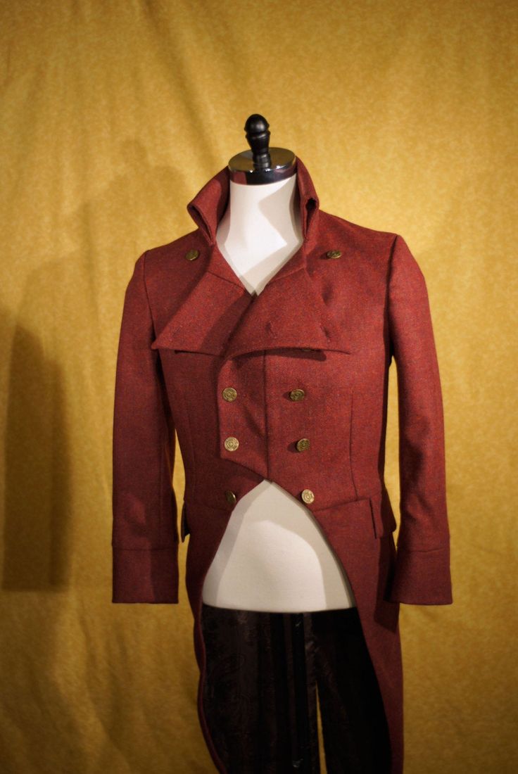 "ABOUT THIS STYLE: Cut in a double-breasted military style for a plastron effect with a center front seam that allows you to wear the lapels partially unbuttoned and a stand-up back collar. The fabric is an English woven herringbone tweed that is both luxurious and rustic. CUSTOM FROCKS AND TAILS: All of our morning coats and tailcoats are custom----So just let us know what you might like and we can design something for you. Any fabric, silhouette, or trim is possible. For about $100 we can also Fitted Double-breasted Tweed Jacket For Fall, Fitted Stand Collar Pea Coat For Business, Fitted Pea Coat With Stand Collar For Business, Semi-formal Fitted Double-breasted Wool Coat, Fitted Tweed Outerwear With Buttons, Military Style Fitted Wool Pea Coat, Fitted Military Wool Pea Coat, Fitted Tweed Jacket With Button Cuffs And Lapel Collar, Fitted Tweed Jacket With Button Cuffs For Fall