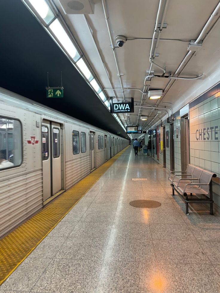 a subway train pulling into the station with its doors open