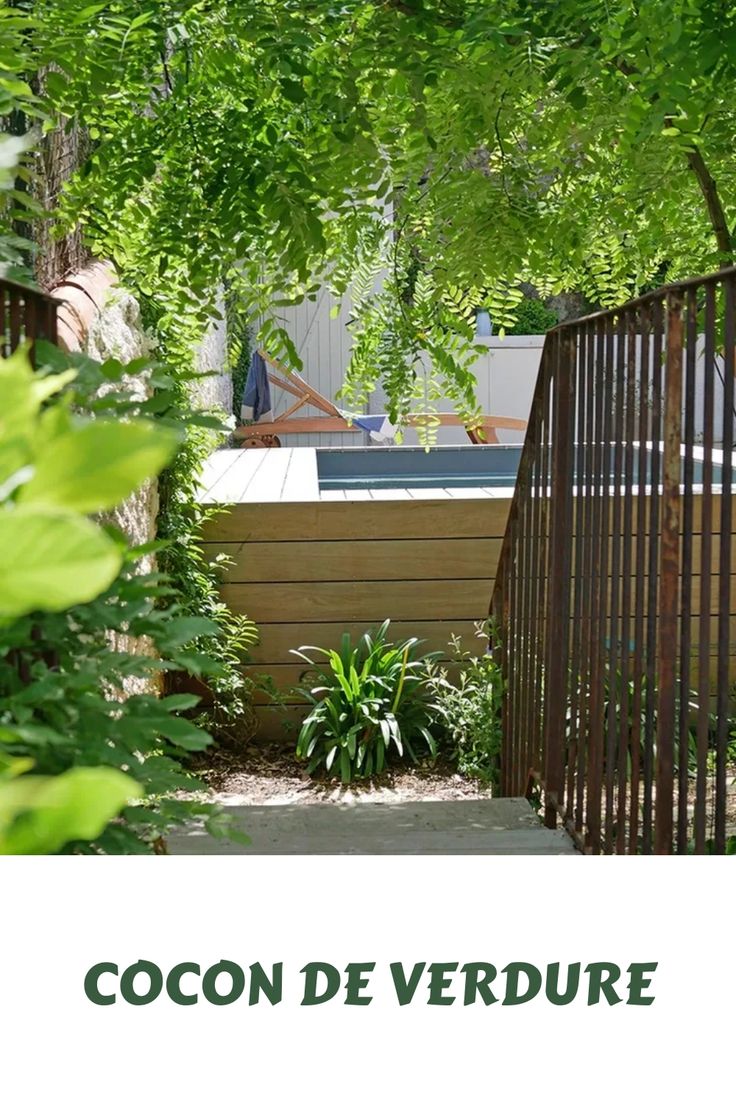 an outdoor hot tub surrounded by greenery and trees with the words cocon de verdure above it