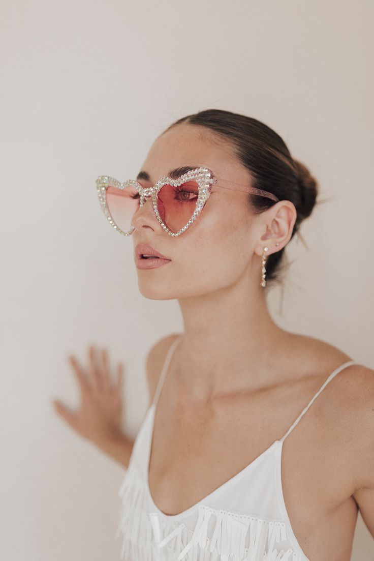 All the heart eyes for these pink sparkle sunnies! Perfect for your bachelorette trip for just yourself or to match with your best girls. Styled here with our Party Girl Mini. Heart-shaped Sunglasses With Heart Print For Party, Glamorous Party Sunglasses With Mirrored Lenses, Heart-shaped Party Sunglasses With Heart Print, Pink Cat Eye Sunglasses With Gradient Lenses For Party, Glamorous Pink Sunglasses For Party, Pink Heart-shaped Sunglasses With Mirrored Lenses, Glamorous Pink Party Sunglasses, Glamorous Party Sunglasses With Gradient Lenses, Pink Tinted Sunglasses For Party