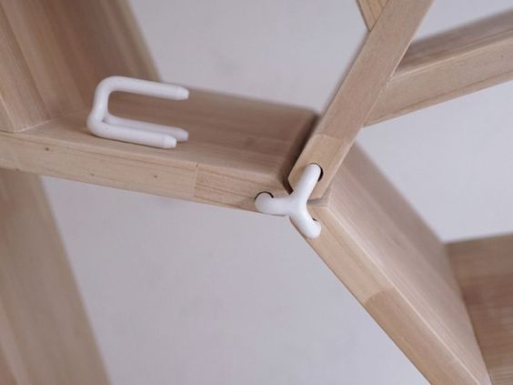 a wooden shelf with two white handles on it