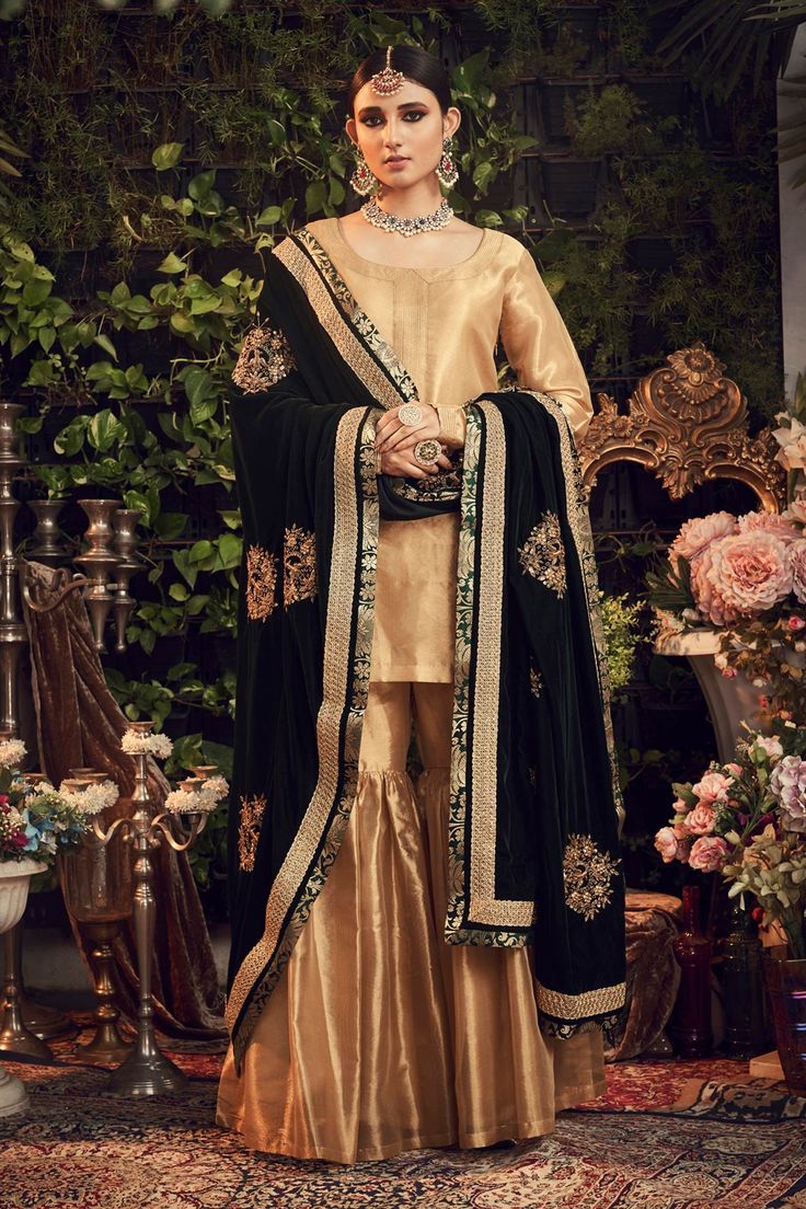 Oxidised gold kurta with embroidered neckline, cuffs and comes with gharara. Paired with silk velvet floral embroidered green dupatta.
Component: 3
Embroidered
Neckine: Round
Sleeve Length: Full
Fabric: Silk Tissue, Silk Velvet
Color: Gold
Embroidered dupatta
Zardosi embroidery - Aza Fashions Luxury Silk Thread Elegant Dupatta, Festive Gold Palazzo Set For Designer Wear, Festive Gold Designer Palazzo Set, Festive Gold Designer Sharara, Elegant Sharara With Gold Embroidery In Traditional Drape, Designer Gold Sharara With Zari Work, Elegant Sharara With Gold Embroidery And Traditional Drape, Elegant Sharara With Gold Embroidery For Festive Occasions, Elegant Sharara With Gold Embroidery