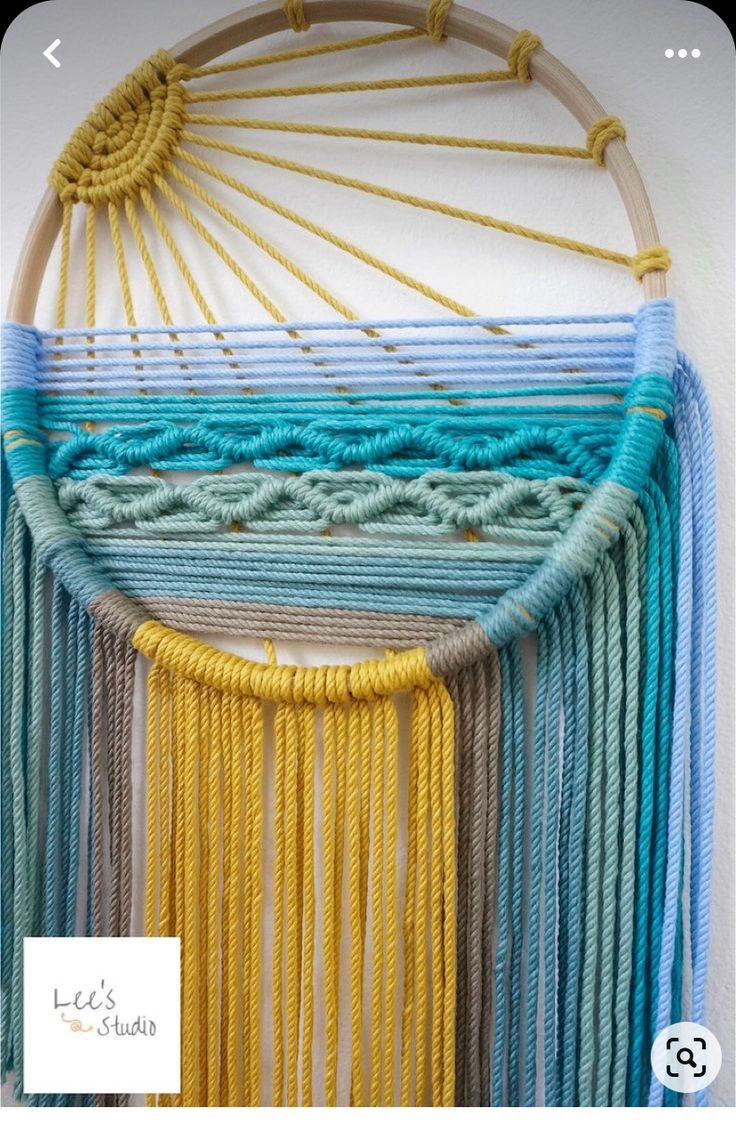 a wall hanging made with yarn and rope