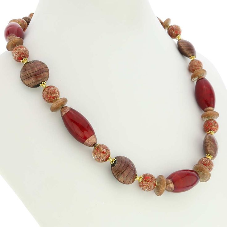 This stunning necklace is a rare Venetian glass treasure with its unique combination of elegant shapes, unique patterns, and deep gorgeous colors. Stylish beads of various shapes intertwine effortlessly and create a tasteful and artful design. The necklace features a mix of gorgeous cranberry and shimmering cocoa colors. The use of avventurina technique adds delicate gold sparkles for an exquisite and timeless look. Hand-blown and designed by Murano glass artists, this versatile piece showcases Oval Glass Gemstone Bead Necklaces, Glass Necklaces With Oval Gemstone Beads, Oval Gemstone Bead Necklaces, Unique Glass Single Strand Necklace, Elegant Multicolor Czech Glass Necklaces, Elegant Multicolor Glass Necklaces, Unique Single Strand Glass Necklaces, Unique Single Strand Glass Necklace, Elegant Glass Beaded Necklaces With Oval Beads