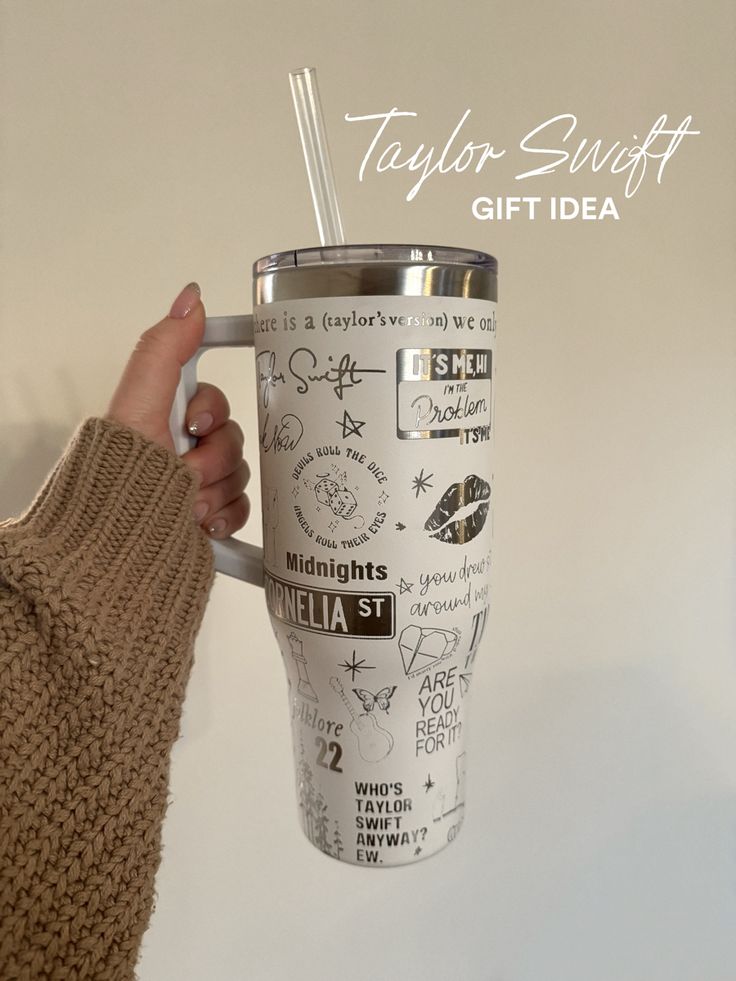 a person holding a coffee cup with writing on it and the words taylor swift gift idea