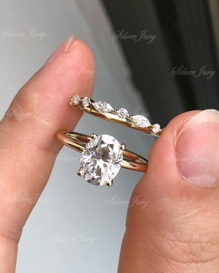 a person holding an engagement ring in their hand with the diamond on it's side