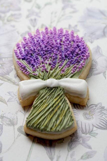 two decorated cookies with purple flowers on them