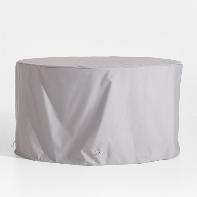 a round table covered with a white cover on it's side, sitting in front of a white background