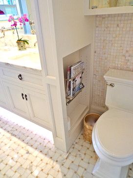 a white toilet sitting in a bathroom next to a sink