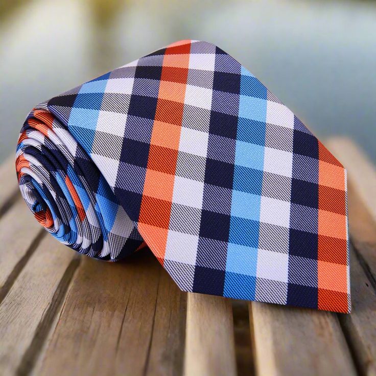 This silk necktie features a striking combination of shades of blue and orange arranged in a classic plaid pattern. The contrasting colors make it a bold accessory that effortlessly blends traditional design with modern flair, making it perfect for various occasions. Dress Shirts: White Dress Shirt: A crisp white dress shirt allows the vibrant blue and orange hues of the tie to take center stage, creating a clean and balanced look suitable for both formal and casual settings. Light Blue Dress Sh Charcoal Gray Suit, Light Blue Dress Shirt, Light Blue Dress, White Dress Shirt, Orange Hues, Navy Blue Suit, Bold Accessories, Light Blue Dresses, Blue Shirt Dress