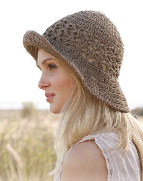 a woman wearing a brown crochet hat