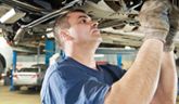 a man working on the underside of a car