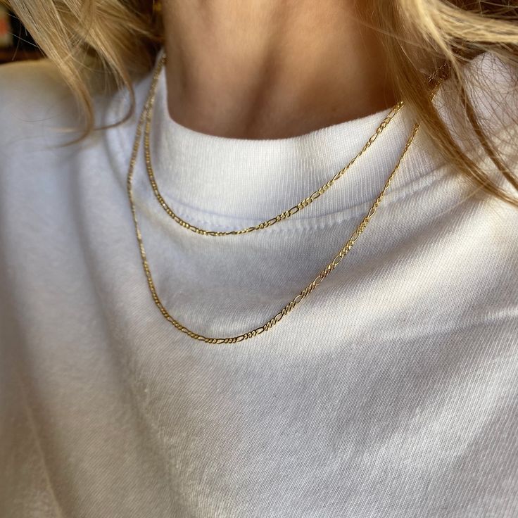 A great addition to our necklace collection. The thin Figaro Chain. Only 1.5mm and a delicate style to make you flourish. Metal: 18k gold-filled 1/20 Wide: 1.5mm 3x1 link pattern Figaro Chain Available in: 16 inches, 18 inches + 2 inches extender 20 inches Hypoallergenic + Waterproof Made in Brazil Gold Figaro Chain, Sophisticated Jewelry, Figaro Chain Necklace, Necklace Collection, Ring Bag, Figaro Chain, Figaro Chains, Anklet Bracelet, Pendant Rings