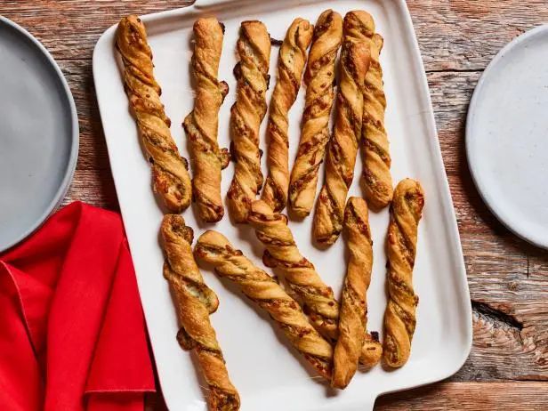 some bread sticks are on a white plate