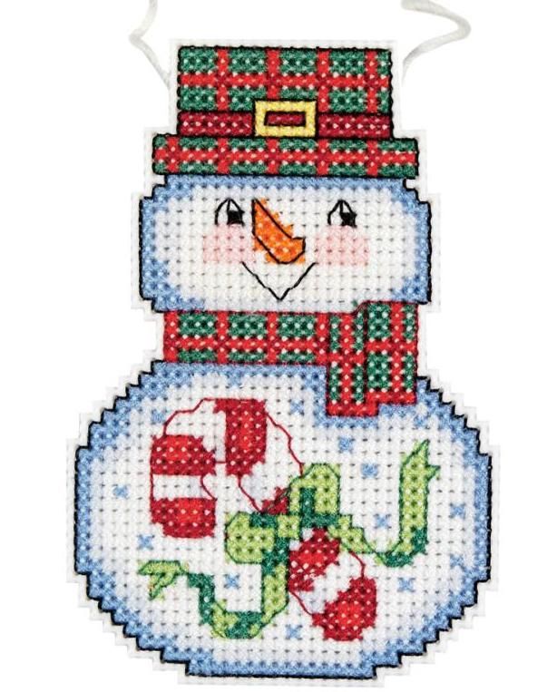 a cross stitch snowman ornament hanging from a string