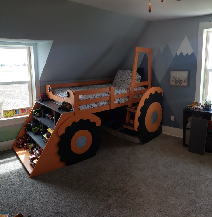 a child's bedroom with a large bed made to look like a tractor track