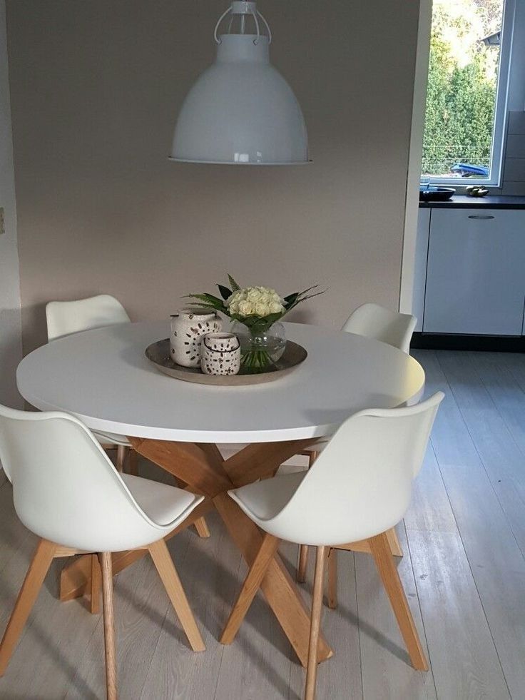 a white table with four chairs around it