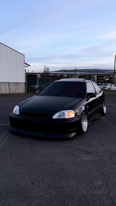 a black car parked in a parking lot