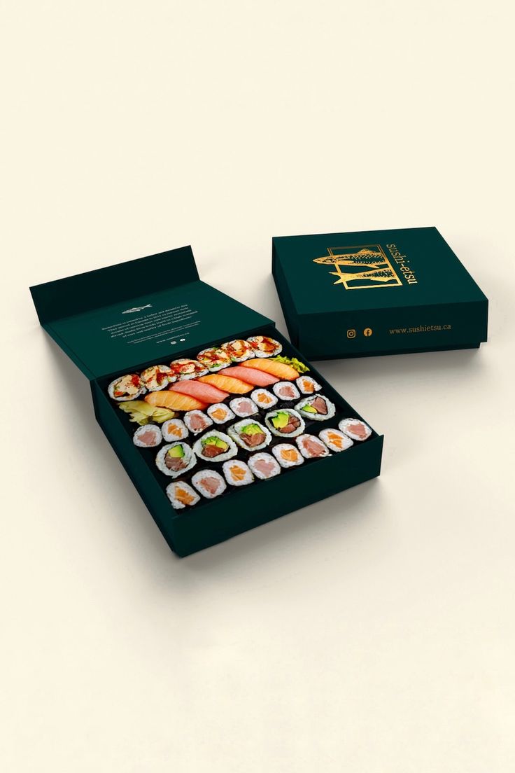 an open box with some sushi on it