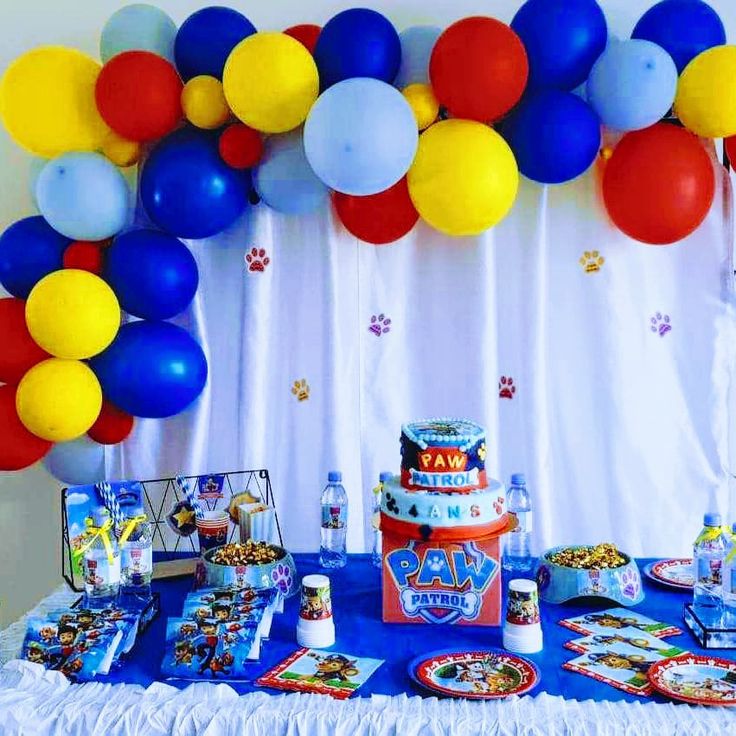 a birthday party with balloons and cake