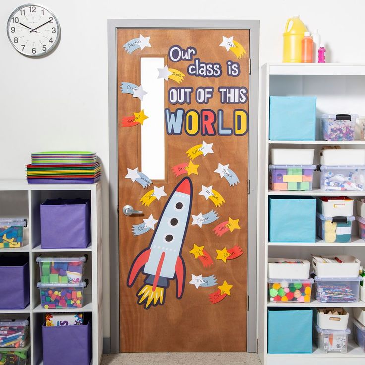 a classroom door decorated with an image of a rocket ship and words that read our class is out of this world