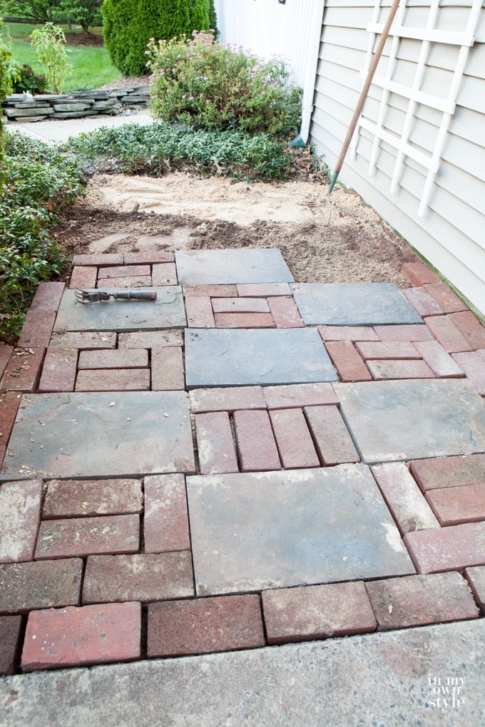 a brick walkway in front of a house