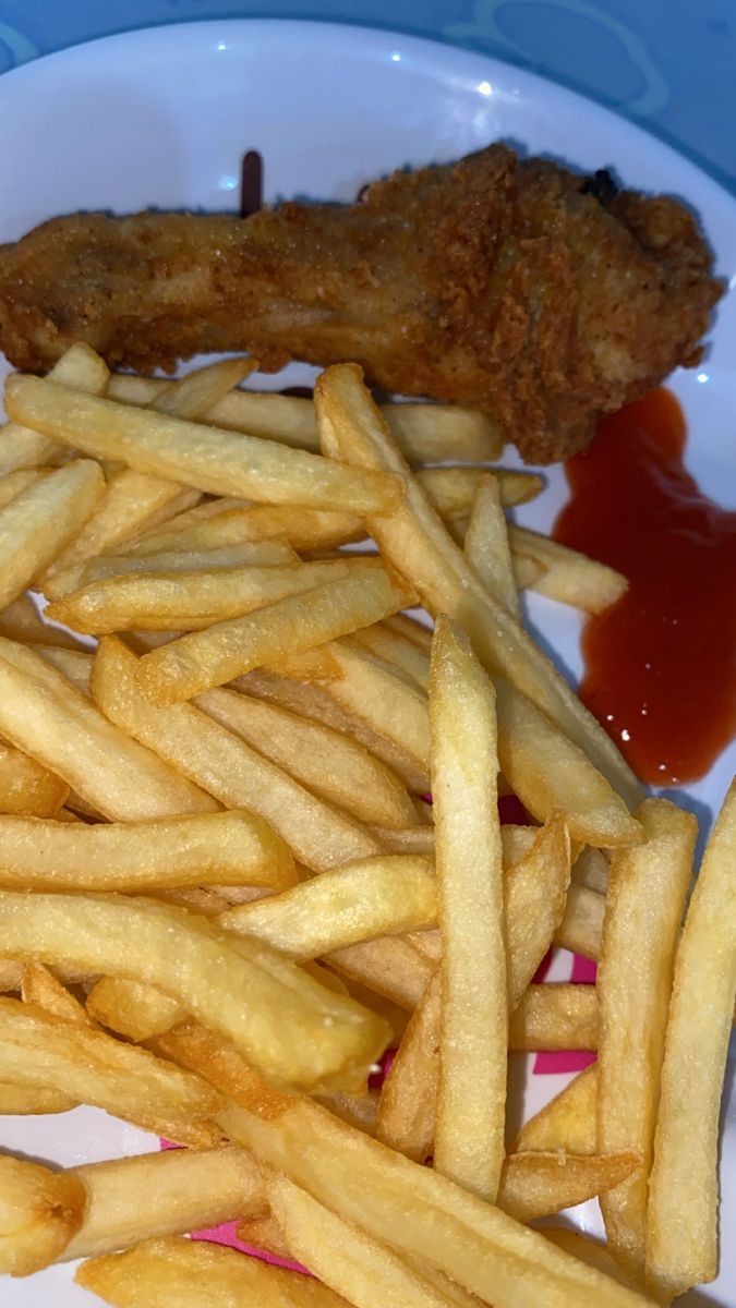 fried chicken and french fries on a plate with ketchup