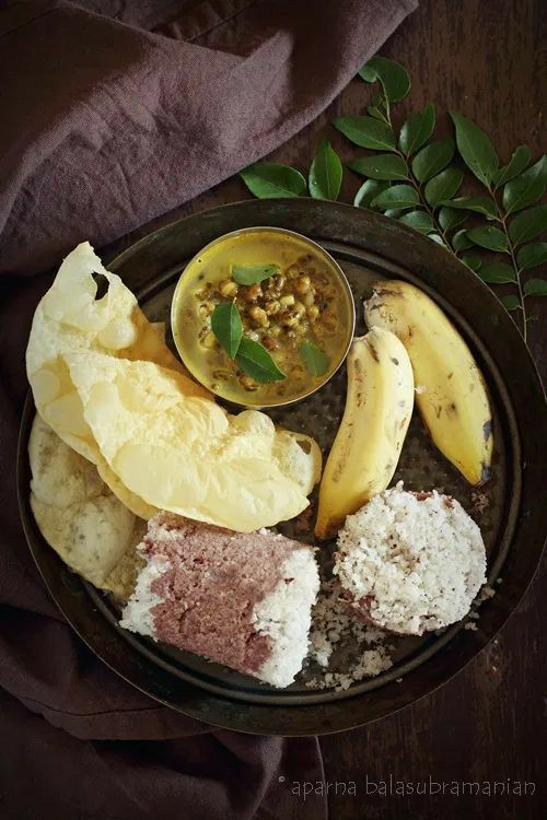 a plate filled with different types of food on top of a wooden table next to a purple cloth