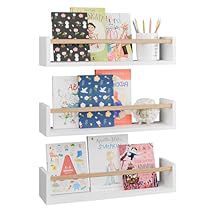 three white shelves with greeting cards and stationery items on each shelf, one is empty