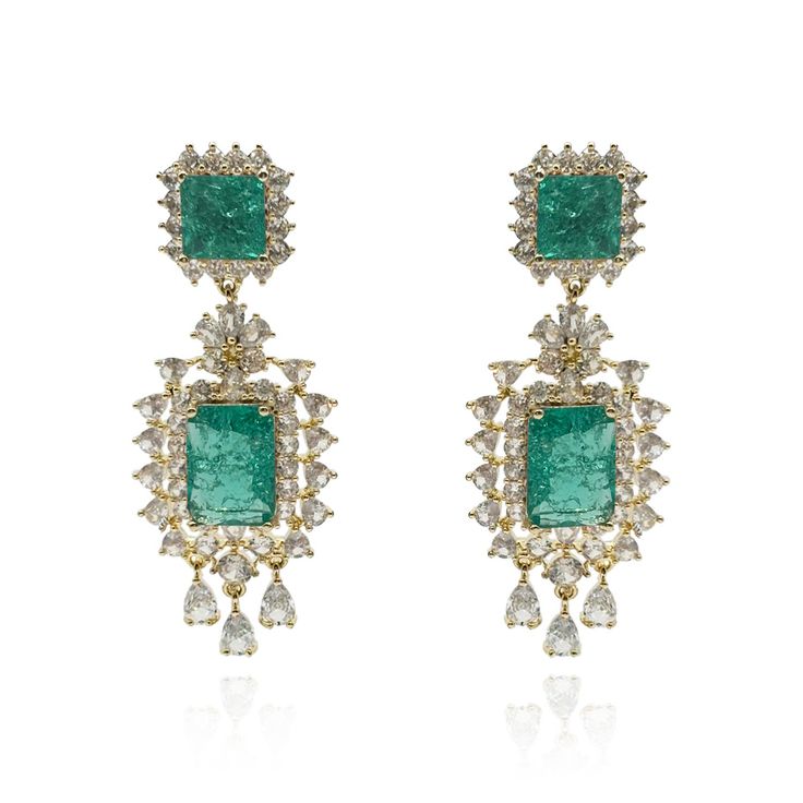 Elevate your elegance with our beautiful Emerald Crystal Earrings, delicately set in rhodium-plated brass. The enchanting shade of green exudes a serene and calming aura, making these earrings a timeless addition to your jewelry collection. Crafted with meticulous attention to detail, these earrings boast a captivating design that effortlessly captures the essence of sophistication. The shimmering aquamarine crystals sparkle with every movement, adding a touch of glamour to any ensemble. Avoid c Luxury Green Gemstone Earrings, Green Hand-set Diamond Earrings, Luxury Green Diamond Earrings Gift, Luxury Green Diamond Earrings For Gift, Green Hand Set Diamond Earrings, Luxury Green Diamond Earrings For Wedding, Green Sterling Silver Luxury Diamond Earrings, Luxury Green Sterling Silver Diamond Earrings, Green Fusion Style Drop Earrings