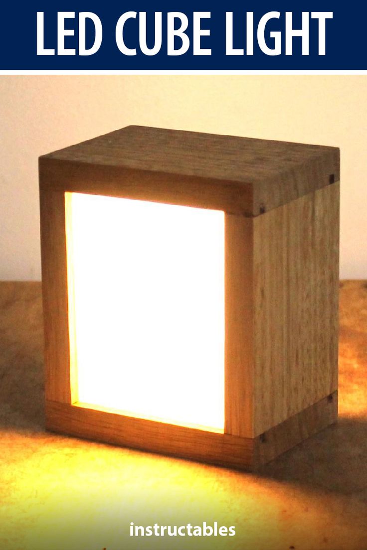 a wooden cube light sitting on top of a table