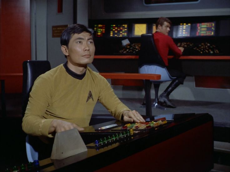 a man sitting at a desk in front of a computer