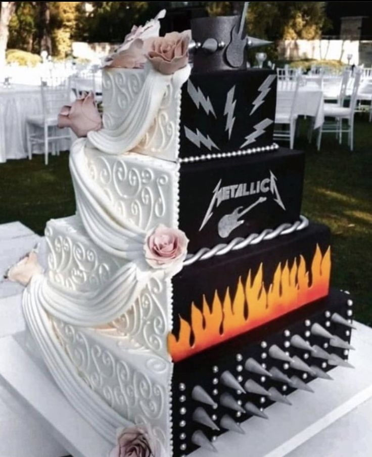 a three tiered wedding cake with pink roses on top and an iron maiden design