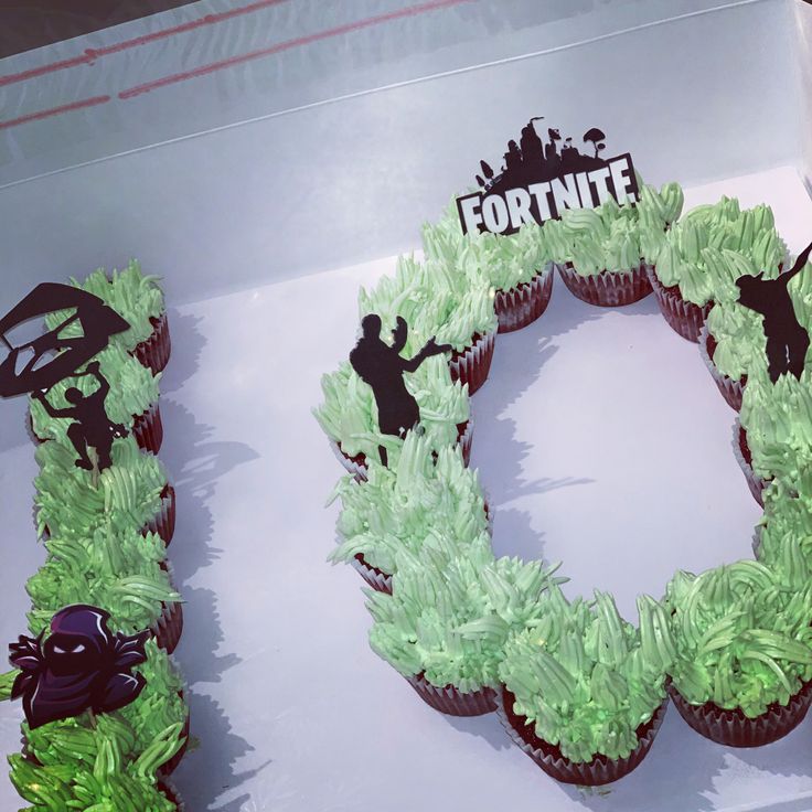 the cupcakes are decorated with green frosting and black silhouettes on them