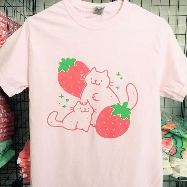 Strawberry Cat Shirt | crowlines Cute Cotton T-shirt With Funny Print, Summer Cotton Shirt With Cat Design, Trendy Cotton Shirt With Cartoon Print, Cute Cotton T-shirt With Cartoon Print, Casual Summer Shirt With Cat Design, Summer Cotton T-shirt With Cat Print, Casual Cat Design Short Sleeve Shirt, Casual Short Sleeve Shirt With Cat Design, Casual Short Sleeve Shirt With Cat Print