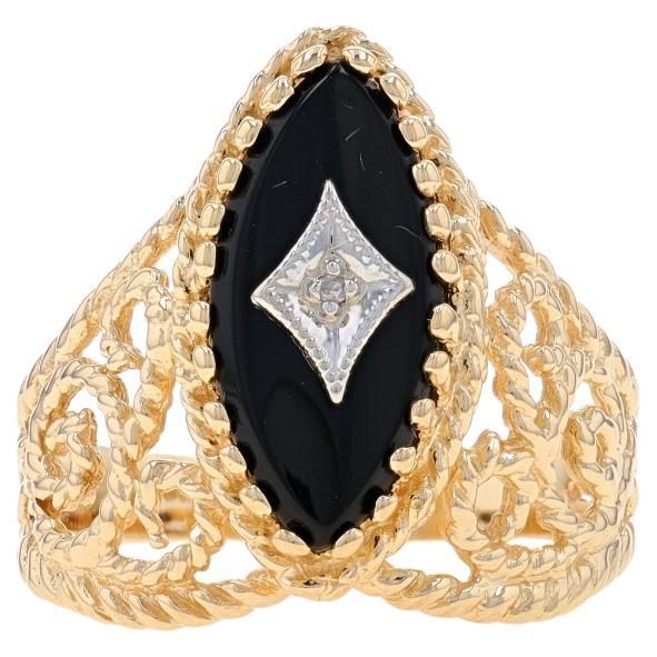 Size: 7 Sizing Fee: Up 2 1/2 sizes for $35 or Down 2 sizes for $30 Metal Content: 14k Yellow Gold & 14k White Gold Stone Information Natural Onyx Cut: Marquise Cabochon Color: Black Natural Diamond Cut: Single Stone Note: (one small accent) Style: Solitaire with Accent Features: Open Cut Rope Detailing with Milgrain Accents Measurements Face Height (north to south): 3/4" (18.3mm) Rise Above Finger: 1/4" (5.6mm) Weight: 4.1 Grams Stamps: 14k, JFD Condition: Pre-Owned Professionally cleaned, polis Rise Above, La Face, Single Stone, Gold Stone, Yellow Gold Rings, Cocktail Rings, Gold Ring, Natural Diamonds, Onyx