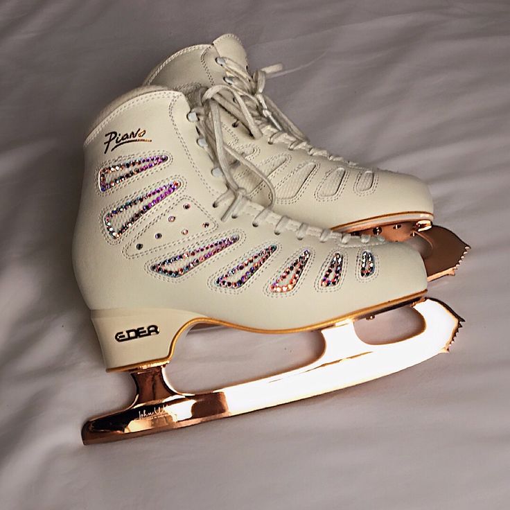 a pair of ice skates sitting on top of a bed