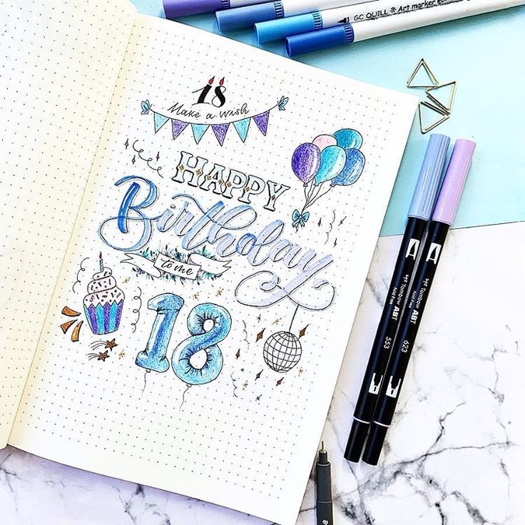 an open notebook with the words happy birthday written on it and some markers next to it