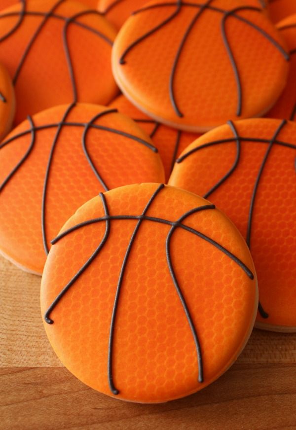 basketball cookies with chocolate icing are arranged on a table