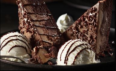 chocolate dessert with ice cream on a black plate